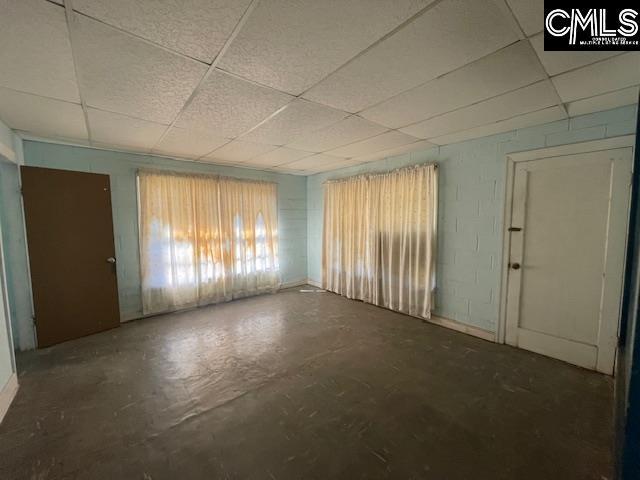 empty room featuring a paneled ceiling