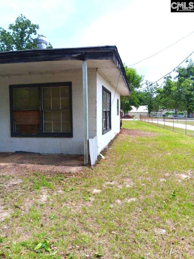 view of side of home featuring a lawn