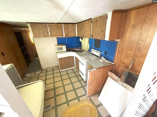 kitchen with wood walls and white appliances