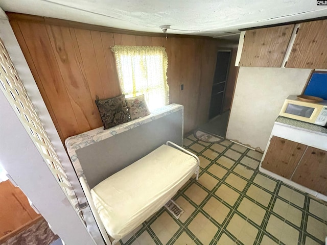 bedroom with wood walls