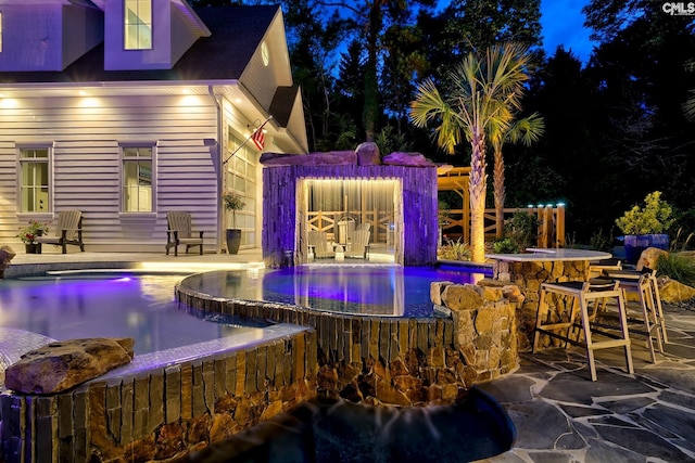 view of swimming pool featuring outdoor dry bar and a pool with connected hot tub