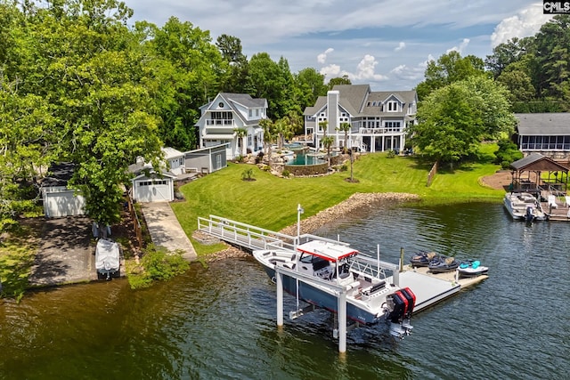 view of dock featuring a lawn, a water view, and boat lift