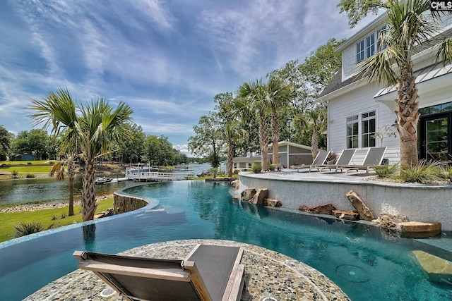 view of swimming pool featuring an infinity pool and a water view