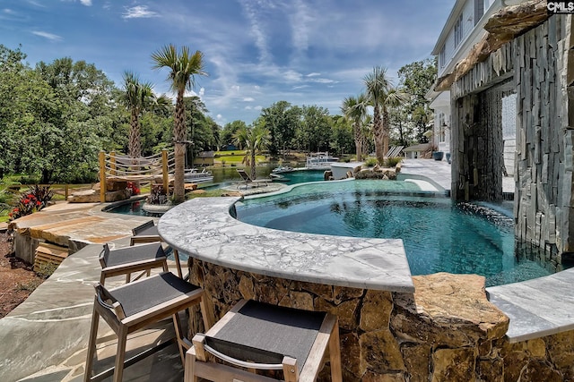 pool featuring a jacuzzi and a patio