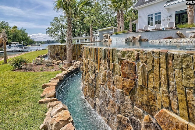 view of swimming pool featuring a lawn