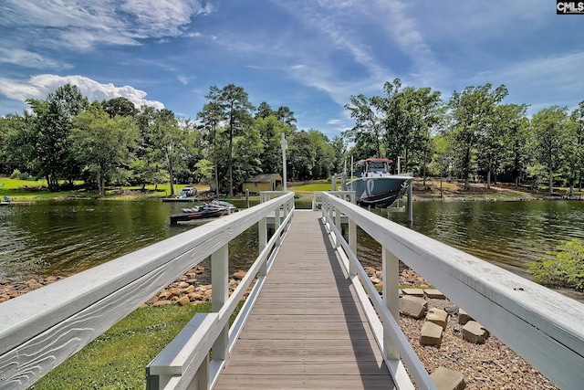 dock area with a water view and boat lift