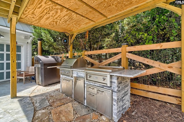 view of patio / terrace featuring a grill and exterior kitchen