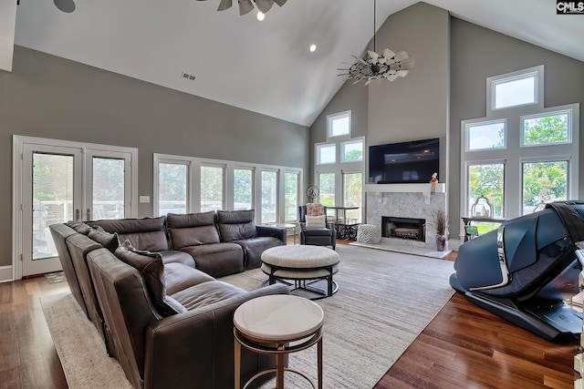 living room featuring a fireplace, visible vents, dark wood finished floors, and french doors