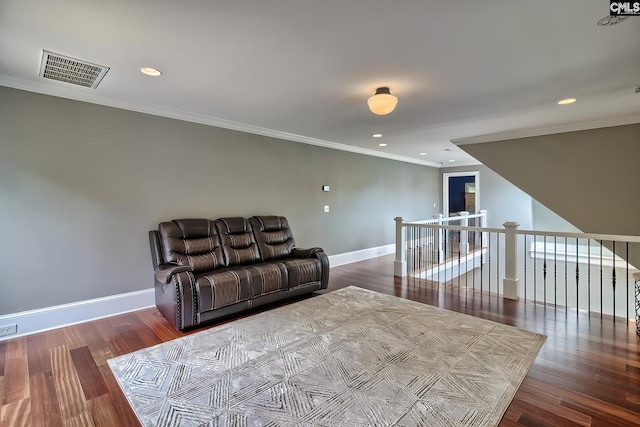 living room featuring wood finished floors, visible vents, and baseboards