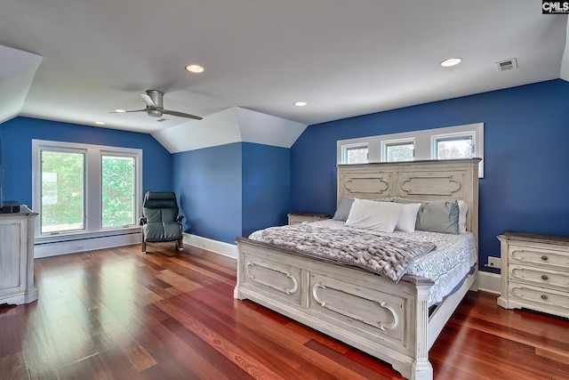 bedroom featuring visible vents, dark wood-type flooring, a baseboard heating unit, vaulted ceiling, and baseboards