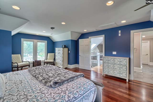 bedroom with dark wood-type flooring, lofted ceiling, baseboards, and recessed lighting