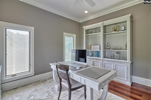 office area featuring a ceiling fan, crown molding, baseboards, and wood finished floors