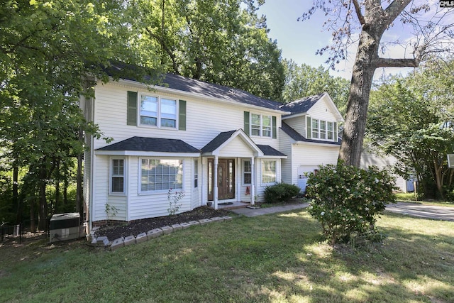 view of front facade featuring a front yard and a garage