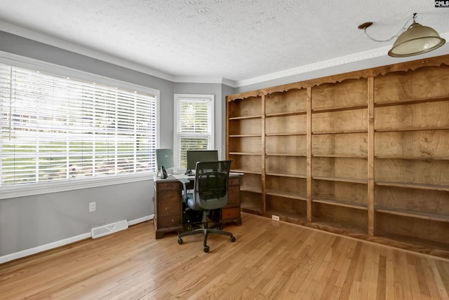 office space featuring crown molding, light hardwood / wood-style floors, and a textured ceiling