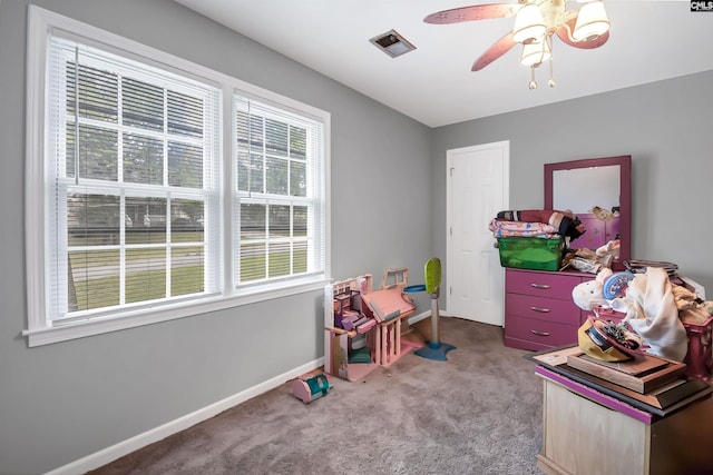 game room with carpet flooring and ceiling fan