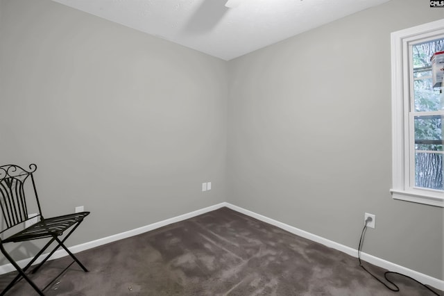 unfurnished room featuring dark carpet