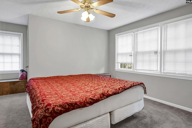 carpeted bedroom with multiple windows and ceiling fan