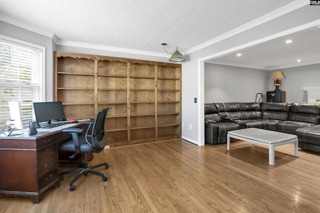 office space featuring a textured ceiling, light hardwood / wood-style floors, and crown molding