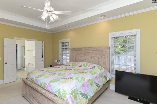 bedroom with a tray ceiling, ceiling fan, crown molding, and light colored carpet