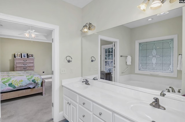 bathroom featuring vanity, ceiling fan, and a tub