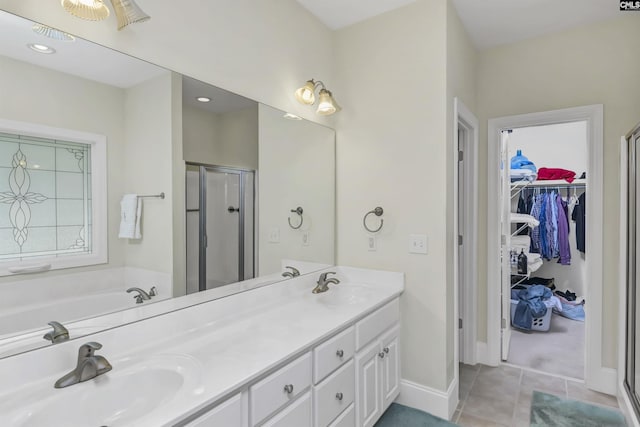 bathroom featuring tile patterned floors, vanity, and a shower with door