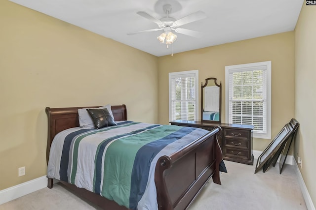 bedroom featuring light carpet and ceiling fan