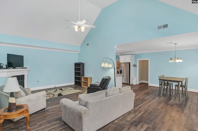 living room with high vaulted ceiling, dark hardwood / wood-style floors, and ceiling fan with notable chandelier