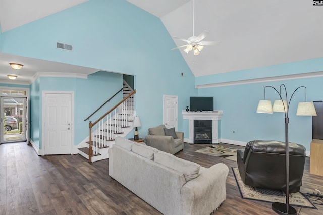 living room with ceiling fan, crown molding, high vaulted ceiling, and dark wood-type flooring