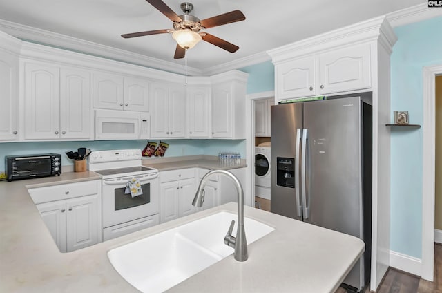 kitchen with white appliances, crown molding, sink, white cabinets, and washer / dryer