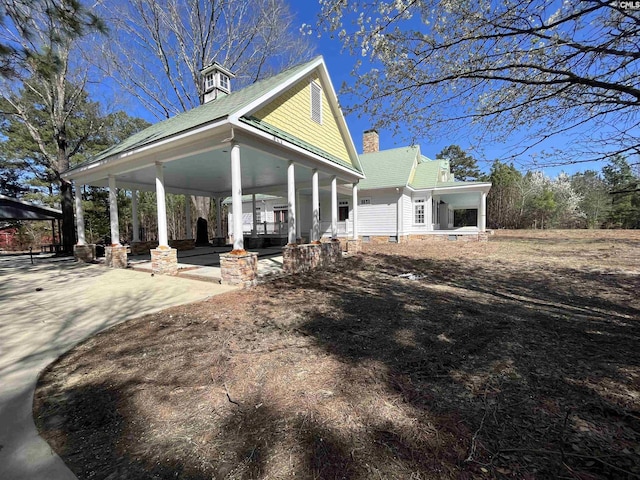 rear view of property with covered porch