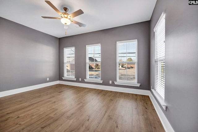 empty room featuring ceiling fan and hardwood / wood-style floors