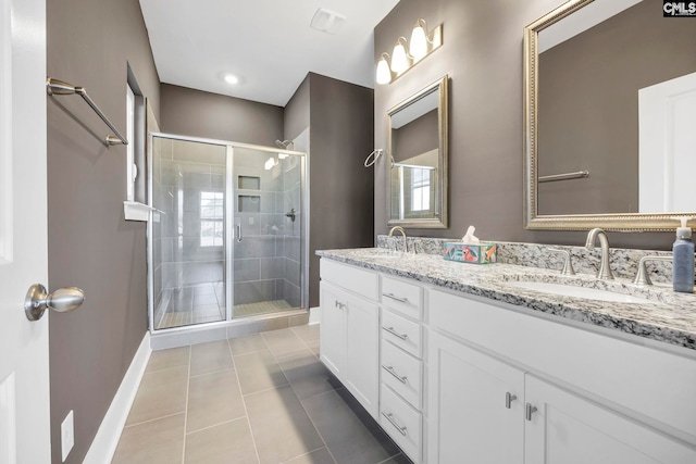 bathroom featuring tile patterned flooring, vanity, and walk in shower