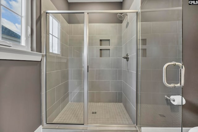 bathroom featuring walk in shower and a healthy amount of sunlight