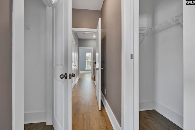 hallway with hardwood / wood-style flooring