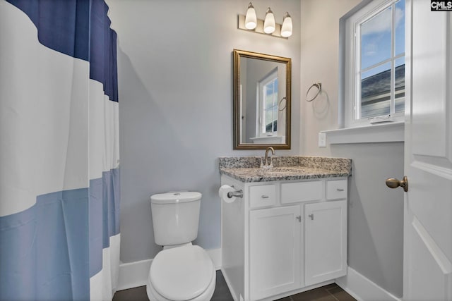 bathroom featuring tile patterned flooring, vanity, a shower with shower curtain, and toilet