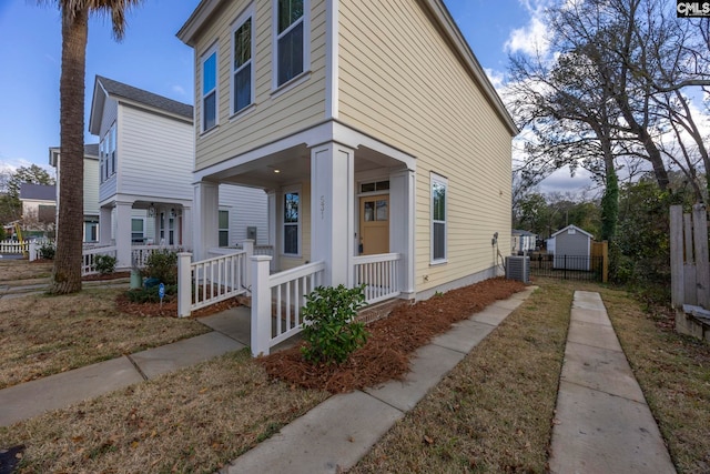 view of side of property featuring central air condition unit and covered porch