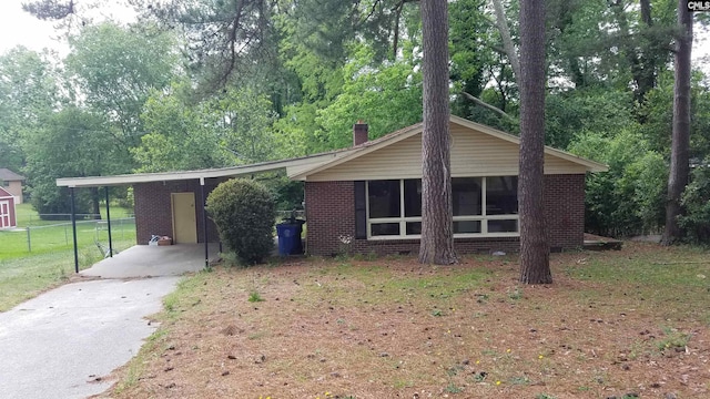 single story home with a carport and a front yard