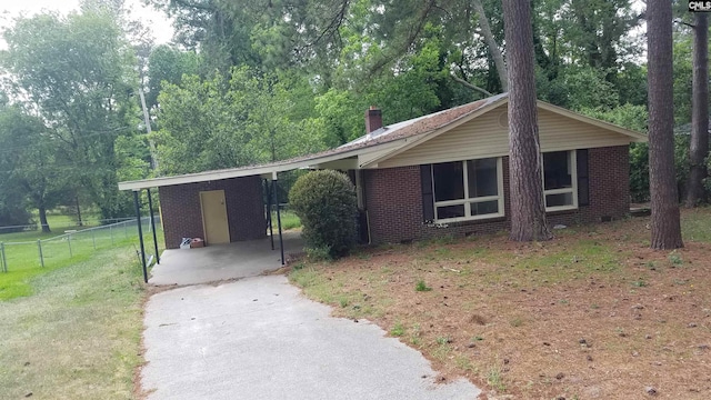 ranch-style home with a front lawn and a carport