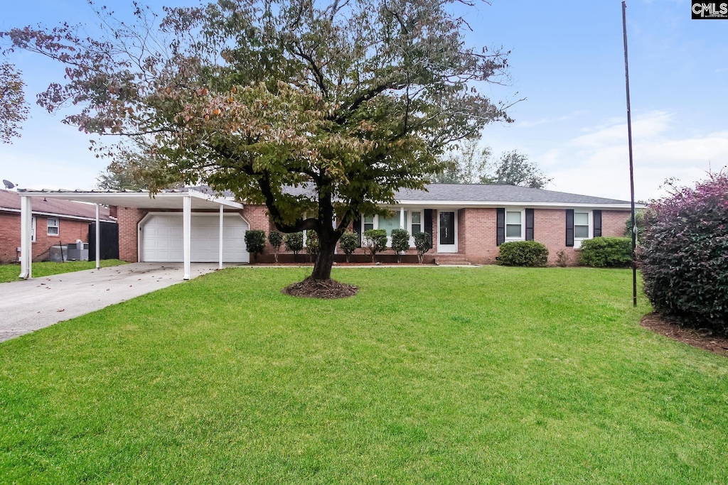 ranch-style house with a garage and a front yard