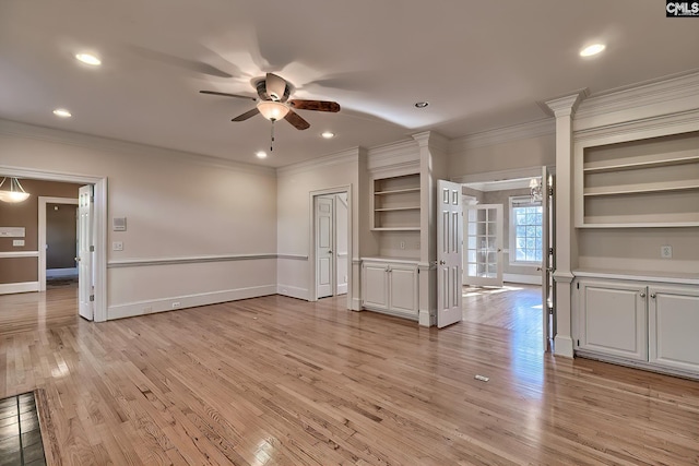 unfurnished living room with built in features, light hardwood / wood-style flooring, ceiling fan, and ornamental molding