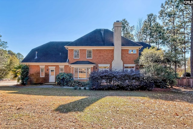 back of property featuring a lawn