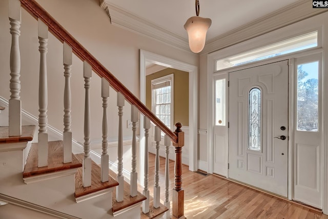 foyer entrance featuring light wood-type flooring and crown molding