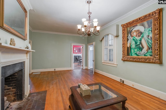 living room with hardwood / wood-style flooring, a notable chandelier, and ornamental molding