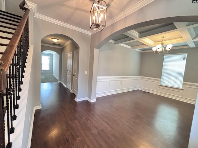 entryway featuring beamed ceiling, an inviting chandelier, ornamental molding, and coffered ceiling