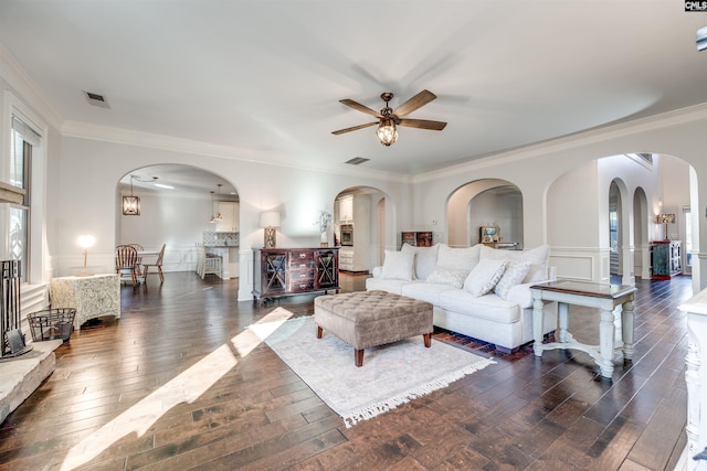 living room featuring crown molding, dark hardwood / wood-style flooring, and ceiling fan