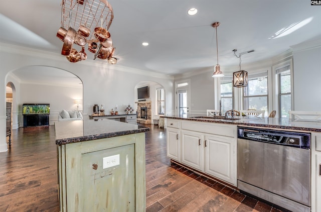 kitchen featuring dark wood-type flooring, sink, dishwasher, a center island, and white cabinetry