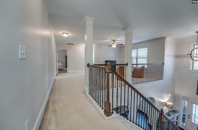 hall featuring a chandelier and light colored carpet