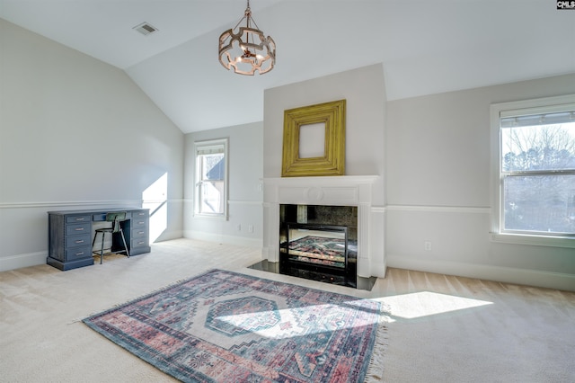 carpeted living room with plenty of natural light, a fireplace, and vaulted ceiling