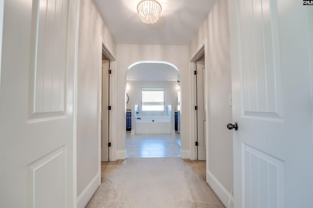 hallway featuring light carpet