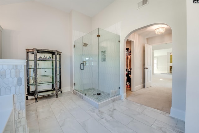 bathroom featuring a shower with door